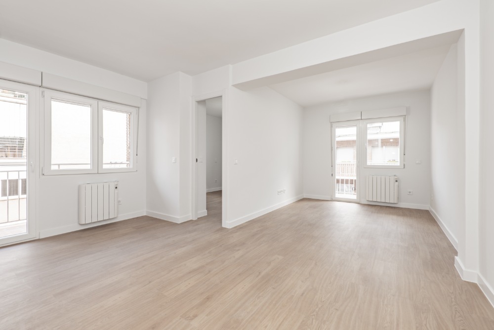 Empty room with light wood flooring