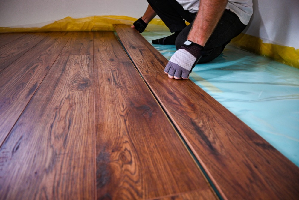 Laying down wooden flooring planks